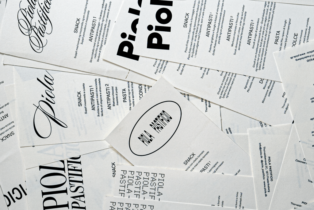 Overlapping Piola menus combining flowing scripts, bold rounded lettering and condensed type in black on white paper.