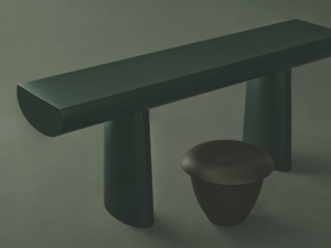 Long dark-green Karakter Bon console beside a low rounded stool on a green studio set.