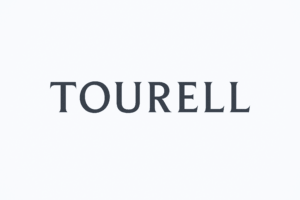 Tourell wordmark in dark uppercase lettering with sharp, flared ends, centred on a pale background.