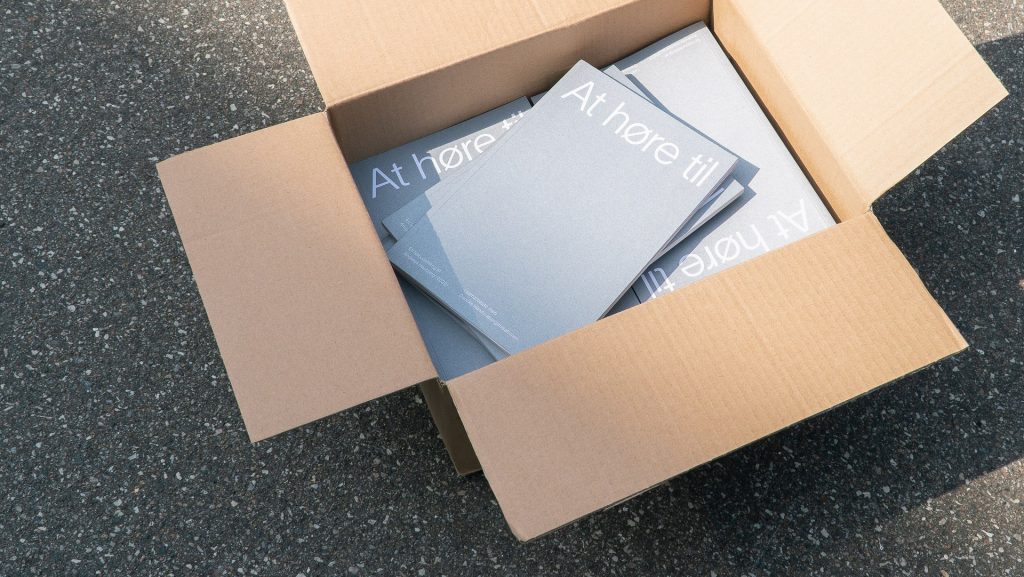 Printed At Høre Til catalogues in a shipping box