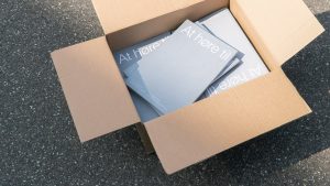 Printed At Høre Til catalogues in a shipping box